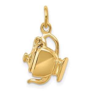 May include: A gold-colored charm in the shape of a pitcher with a handle and a spout. The charm has a loop at the top for attaching to a necklace or bracelet. The pitcher charm is made of a shiny, polished metal.