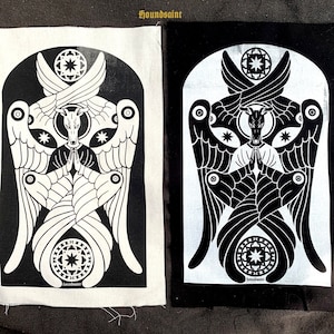 May include: Two fabric patches, one black and one white, each with a symmetrical black and white illustration. The design features a dog-like figure with angel wings, a halo, and geometric shapes. The text "houndsaint" is at the top of the patches.