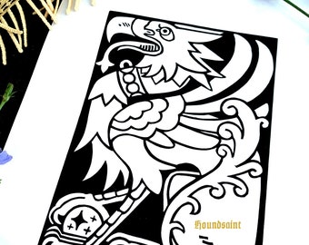 May include: A black and white art print featuring a stylized eagle design. The print includes the text "Houndsaint" and the artist's signature. The artwork is on white paper, with a floral and fabric background.