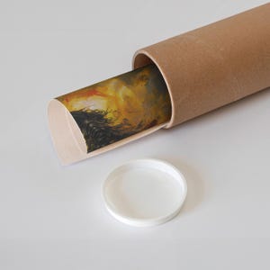 Art print inspired by Elden Ring rolled into a sturdy mailing tube, featuring a glimpse of a dramatic, fiery sunset and dark armored figure. Ideal for safe, stylish delivery of dark fantasy decor to fans and collectors alike.