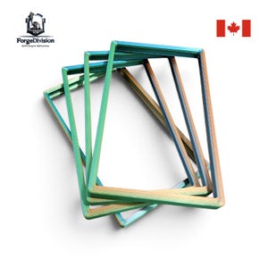 May include: A set of four rectangular frames with a gradient finish shifting between metallic blue, green, and copper tones. The frames are stacked at slight angles, displaying a layered structure with visible 3D printed texture lines.