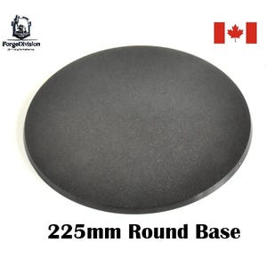 May include: A dark grey, round base with a textured surface, measuring 22.5cm in diameter. The text "225mm Round Base" is printed in black at the bottom. The image also includes the logo of "ForgeDivision" and the Canadian flag.