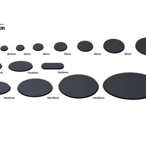 May include: A set of 11 black round and oval-shaped bases for miniature figures, ranging in size from 25mm to 170mm. The bases are made of a smooth, black material.