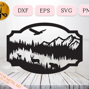 May include: Black and white silhouette of a mountain scene with a lake, trees, a deer, a bear, and a bird flying overhead. The design is framed in a decorative border.