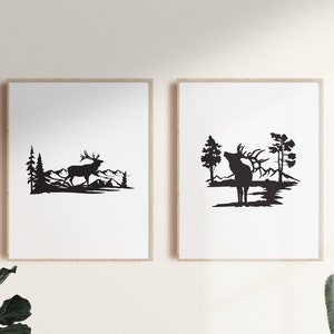 May include: Two black and white silhouette prints of an elk in a forest setting. The elk in the left print is walking, while the elk in the right print is standing with its head raised. Both prints feature a mountain range in the background.