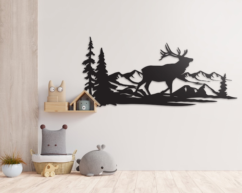 May include: Black metal wall art featuring a silhouette of an elk walking through a mountain landscape with trees.