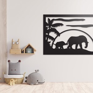 May include: Black metal wall art featuring a silhouette of two elephants walking through a palm tree grove under a sunset.
