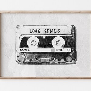 May include: Black and white illustration of a cassette tape with the words "LOVE SONGS" printed on the label. The cassette tape is a Sony brand and says "HF 90" on the side.