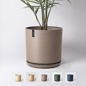 May include: A brown planter with a textured finish and a subtle sheen. The planter is made of a durable material and has a wide, round base. The planter is shown with a green plant inside.