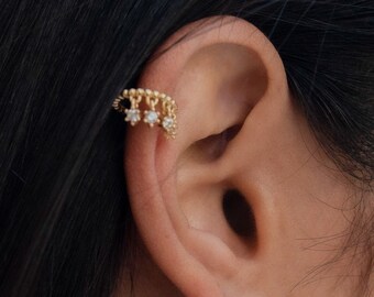 Ear cuff with dangling zirconia charms.