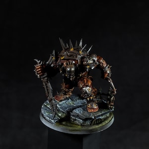 May include: A miniature fantasy figure, predominantly brown and metallic, with detailed armour and spikes. The figure is holding a weapon and stands on a stone base. The dark background highlights the intricate design and craftsmanship of the model.