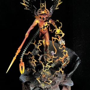 May include: A detailed miniature figure of a demonic entity with fiery orange and yellow accents. The figure has large wings and is holding a glowing weapon. The base is made of stone and metal.