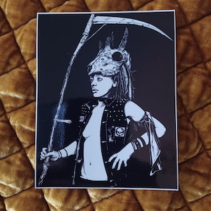 May include: Black and white illustration of a person wearing a skull mask and holding a scythe. The person is dressed in a vest with skull accents. The artwork has a gothic or dark fantasy theme.