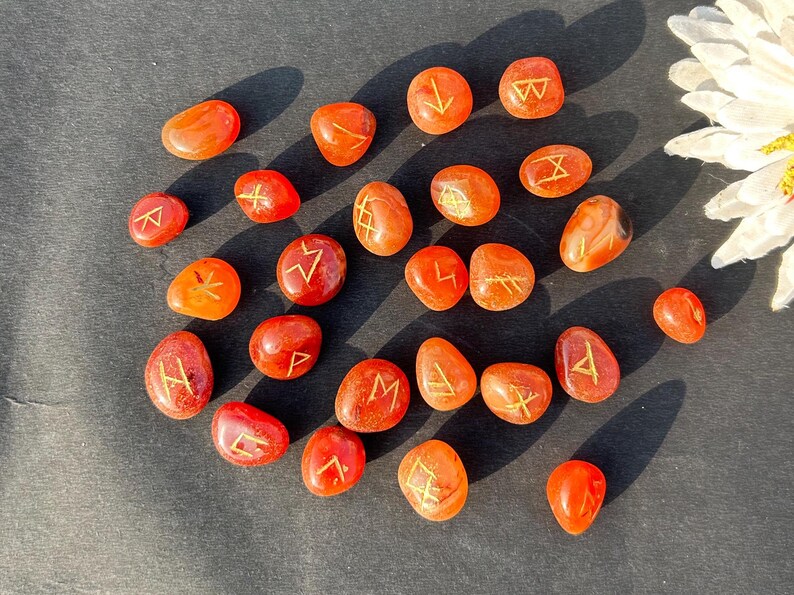 Hand-carved Carnelian Rune Set with engraved gold symbols for divination, meditation, Reiki, and chakra healing rituals
