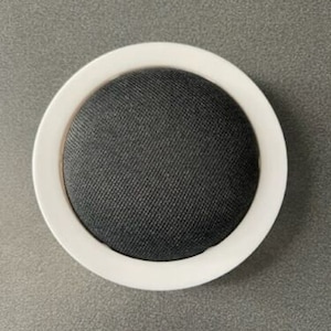 May include: A white round speaker with a black fabric grill.