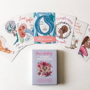 May include: A set of affirmation cards with watercolor illustrations and pink lettering. The cards are part of a deck called "Pura Healing Postpartum Empowerment Deck". The cards feature phrases like "I am safe", "I let go of control", and "I lovingly express my needs".