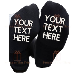 May include: A pair of black socks with white text that reads "YOUR TEXT HERE".