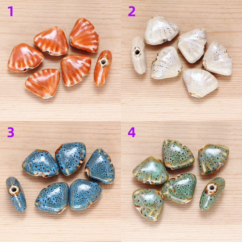 May include: Assortment of ceramic triangle-shaped beads in four different colors: orange, white, blue, and green. The beads have a textured surface and a hole in the center for stringing.