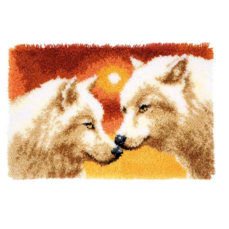 May include: Two white wolves with brown fur accents are facing each other with their noses touching. The background is a sunset with orange, yellow, and red colors.