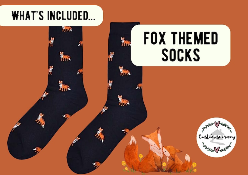 May include: A pair of dark navy blue socks featuring a repeating pattern of small orange and white foxes. The image includes text that reads WHAT'S INCLUDED and FOX THEMED SOCKS, along with a circular logo for Customise crazy and a fox illustration.