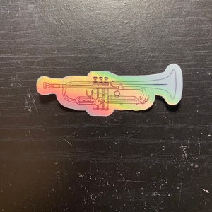 May include: A holographic sticker of a trumpet in a rainbow color scheme.