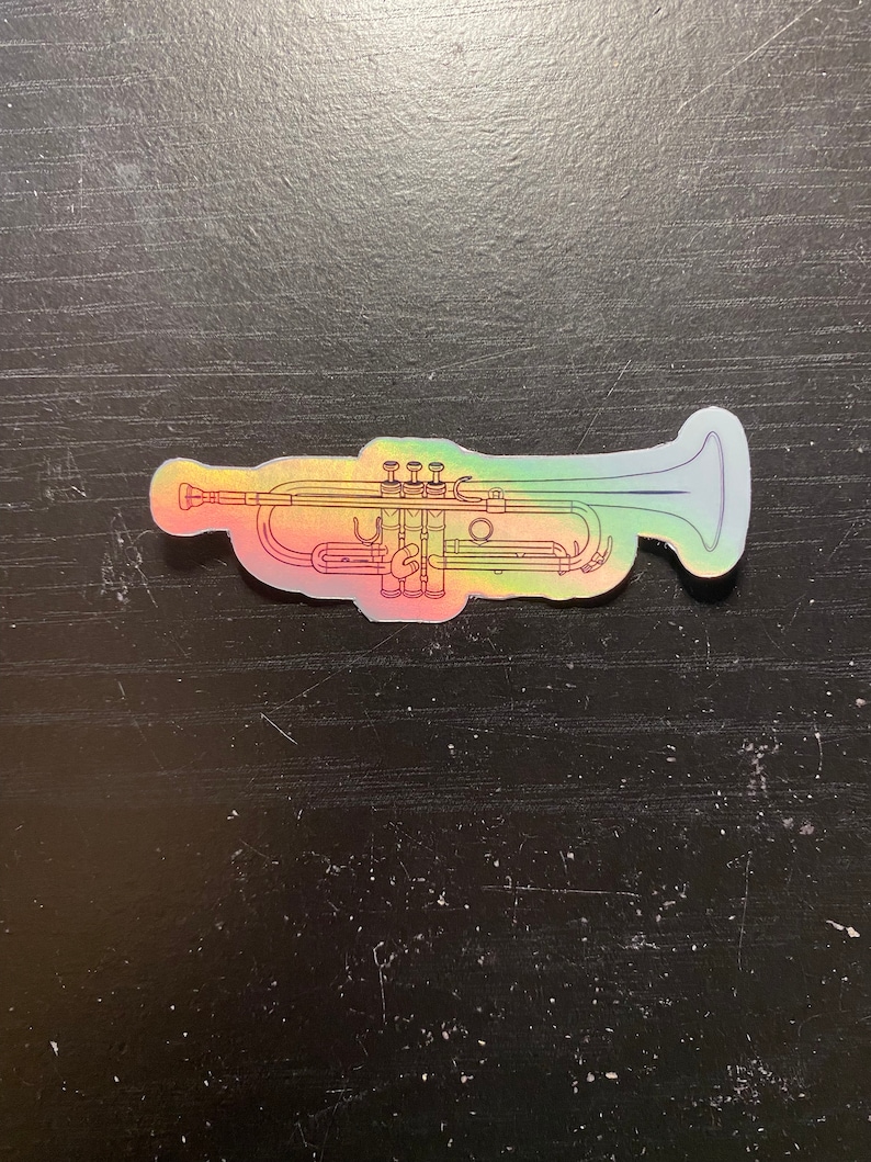 May include: A holographic sticker of a trumpet in a rainbow color scheme.
