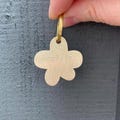 Premium Thick Flower Shaped Gold Dog Tag - Hand Stamped Brass Metal product logo
