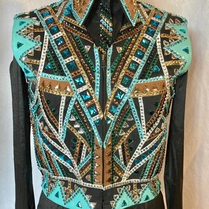 May include: A black show shirt with a turquoise, brown, gold, and green geometric pattern. The shirt has a zip fastening and long sleeves with matching cuffs.