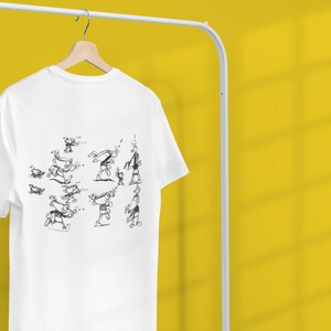 May include: White t-shirt with a black and white illustration of a stick figure performing a series of actions.