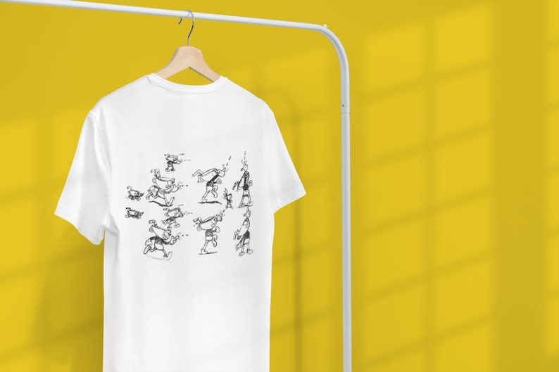 May include: White t-shirt with a black and white illustration of a stick figure performing a series of actions.