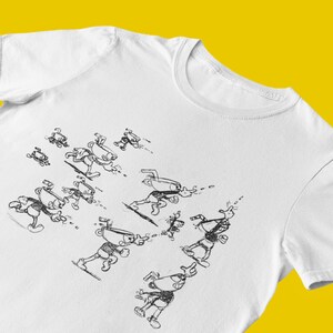 May include: White t-shirt with a black and white illustration of a cartoon character running in various poses.
