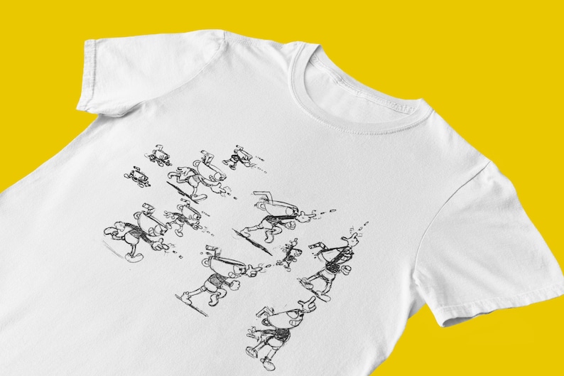 May include: White t-shirt with a black and white illustration of a cartoon character running in various poses.