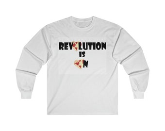 May include: White long-sleeve t-shirt with the text "Revolution is" and a graphic of a broken heart with a world map design.