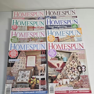 May include: A pile of Australian Homespun magazines, showcasing patchwork, quilting, and stitchery. The covers feature colourful images of quilts, crafts, and sewing projects, with text including "Young Designer" and "Special Mother's Day Buying Guide."