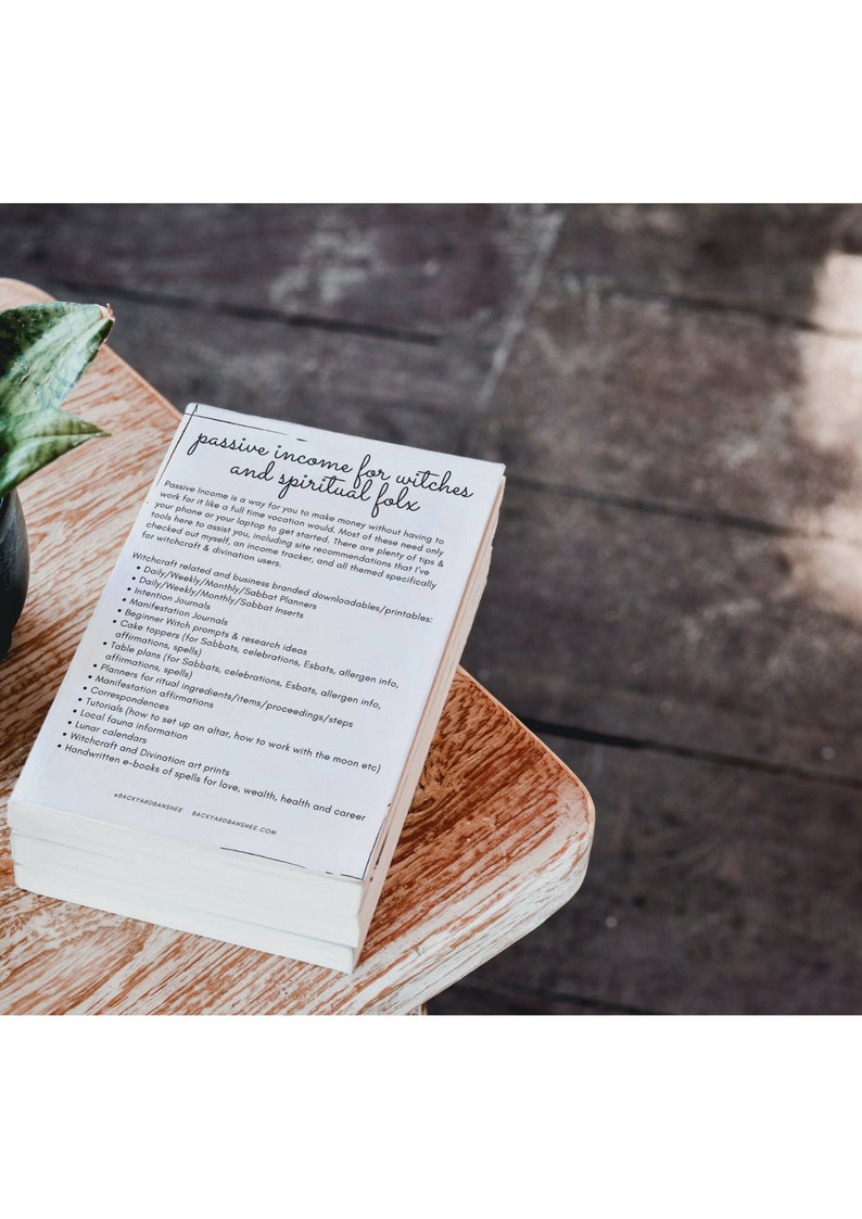 May include: A stack of white papers with black text titled "Passive Income for Witches and Spiritual Folk". The text lists ideas for passive income for witches, such as creating printable planners, journals, and spell books.