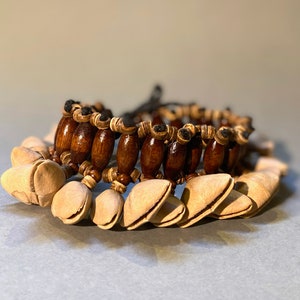 Kenari seed bracelet with strings. A gift for followers of the traditional rituals.