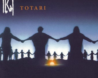 May include: A black and white album cover with the band name "K.I." in large, bold letters and the album title "TOTARI" in smaller letters below. The cover features a silhouette of a group of people holding hands in a circle, with a bright orange light in the center.