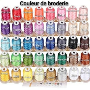 May include: A collection of spools of embroidery thread in various colors, including fuchsia, violet, blue, green, orange, yellow, and white. The spools are arranged in rows on a wooden rack. The text "Couleur de broderie" is visible at the top of the image.