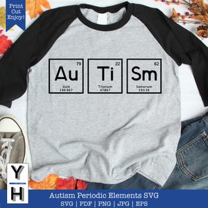 May include: A grey and black baseball tee shirt with a design of three chemical element boxes. The boxes are labelled "Au", "Ti", and "Sm" with their atomic numbers and weights. The text "Autism Periodic Elements SVG" is below the design.