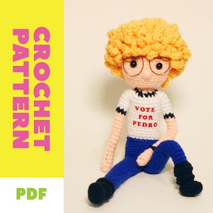 May include: A crocheted doll with a yellow afro, glasses, and a white shirt with the text "VOTE FOR PEDRO." The doll is wearing blue pants and black boots. The image also includes the words "CROCHET PATTERN" and "PDF."