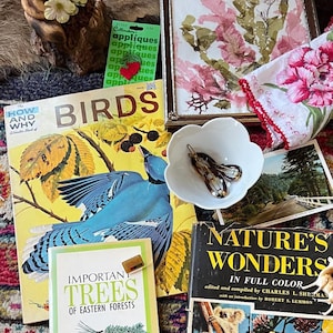 Vintage mystery box in a cottagecore style with pressed flowers, birds and antique books.