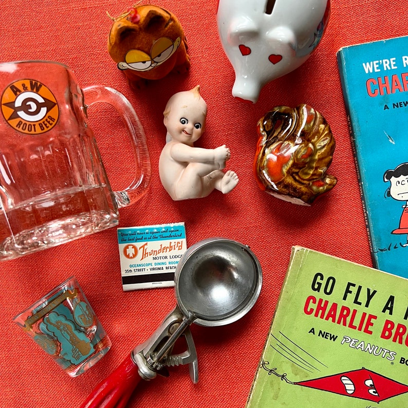surprise box item examples with retro novelty items, kewpies, old advertising glassware, cartoon items, kitchen tools, glassware
