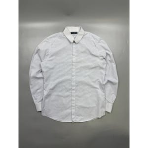May include: A long-sleeve button-down shirt in white with a fine, subtle grey micro-check pattern. The shirt features a structured collar, a front button placket, and barrel cuffs. A small black label is visible on the inside of the collar.