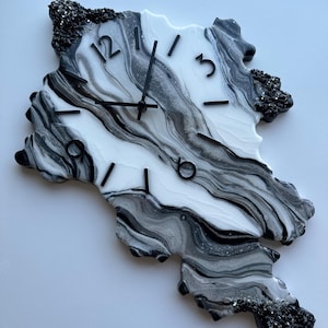 Handmade epoxy resin wall clock with black, white, and silver marbling design. Elegant and unique home decor, perfect as a gift or a stylish