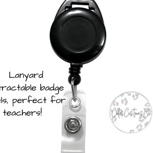 May include: Black retractable badge reel with a clear plastic badge holder. The badge holder has a silver button and a white background with the text "Cole's Customs 19" in black script.