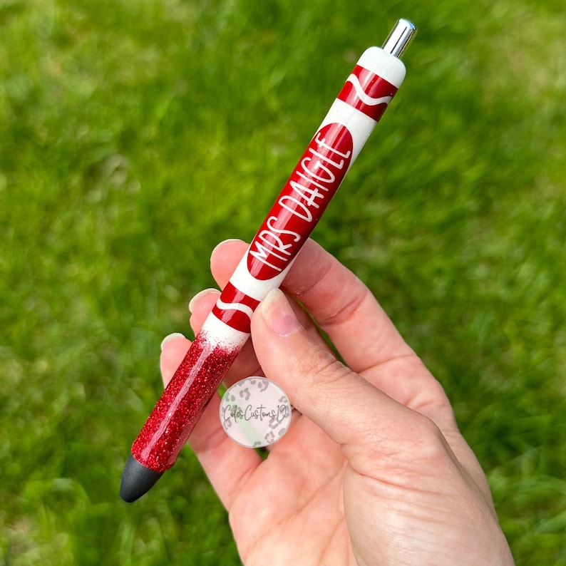 May include: Red and white glitter pen with the text "Mrs. Dagle" on it.