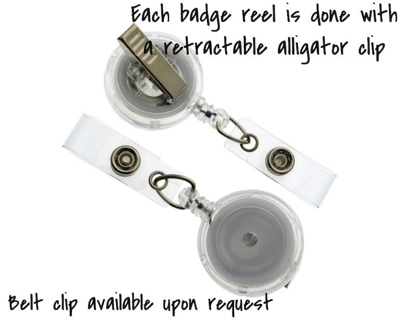 May include: Two clear plastic retractable badge reels with alligator clips. Each reel has a clear plastic strap with a metal button.