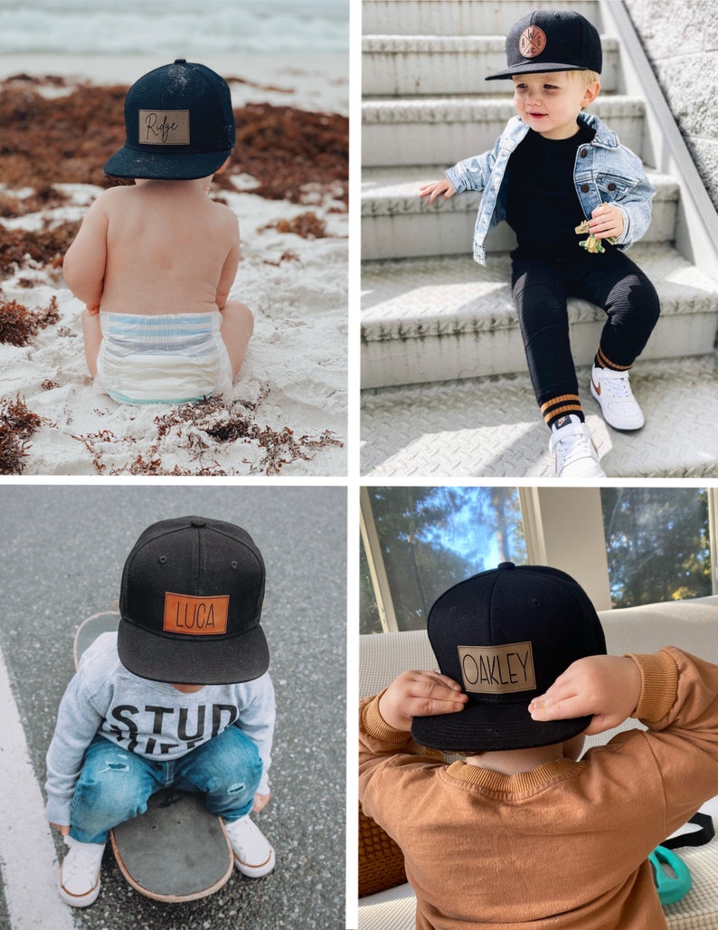 May include: Four black baseball caps with brown leather patches featuring different names. The names on the patches are "Ryder", "Oakley", "Luca", and "Oakley".