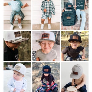 May include: Nine boys wearing personalized baseball caps with leather patches. The caps are in various colors, including gray, black, white, and camouflage. The boys are wearing different outfits, including a blue shirt, a plaid shirt, a black shirt, and a gray shirt. The boys are all smiling and looking at the camera.