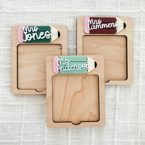 May include: Three wooden frames with a pencil design and a name on each. The names are "Mrs. Jones", "Mrs. Lammers", and "Ms. Anderson".